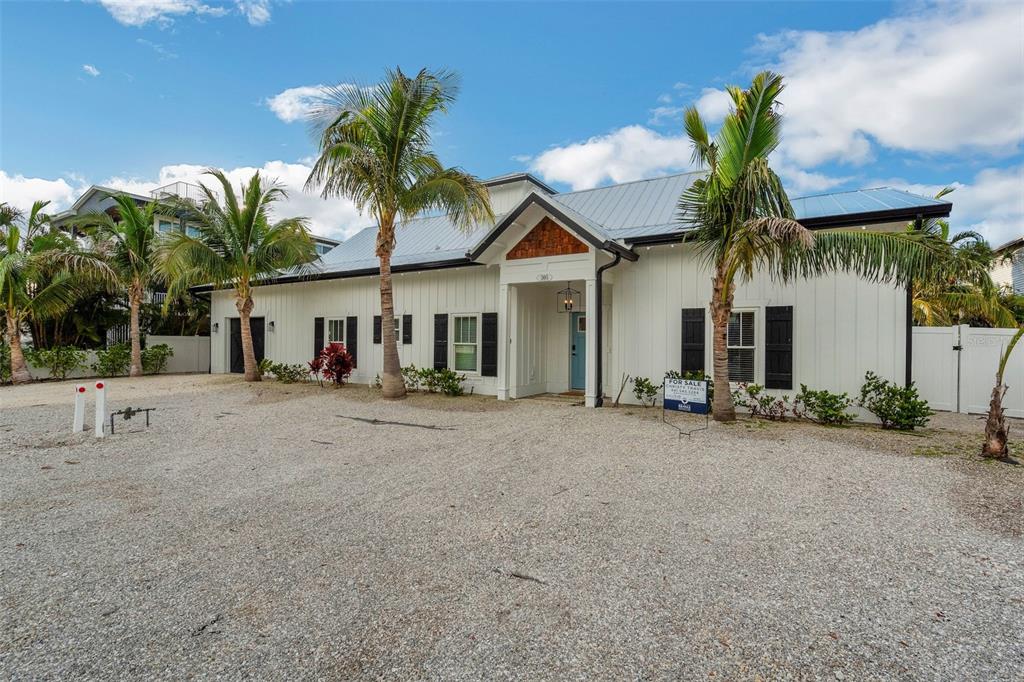 305 73rd Street Holmes Beach, FL 34217 - Photo 24 of 59 a front view of a house with a yard and garage
