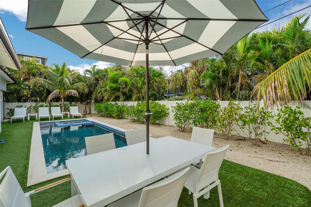 305 73rd Street Holmes Beach, FL 34217 - Photo 29 of 59 a view of a backyard with a patio and garden