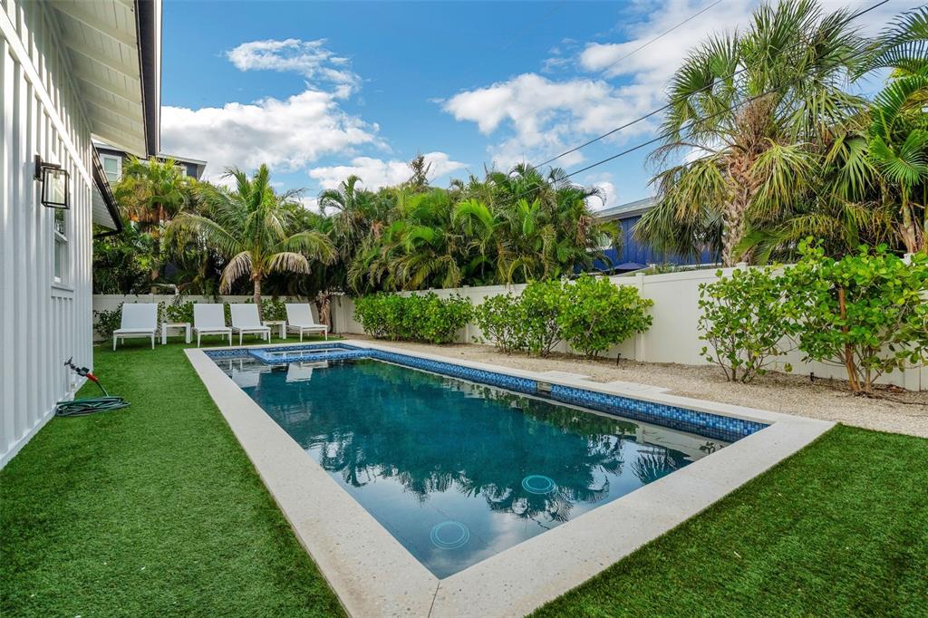 305 73rd Street Holmes Beach, FL 34217 - Photo 30 of 59 a view of a swimming pool with a yard