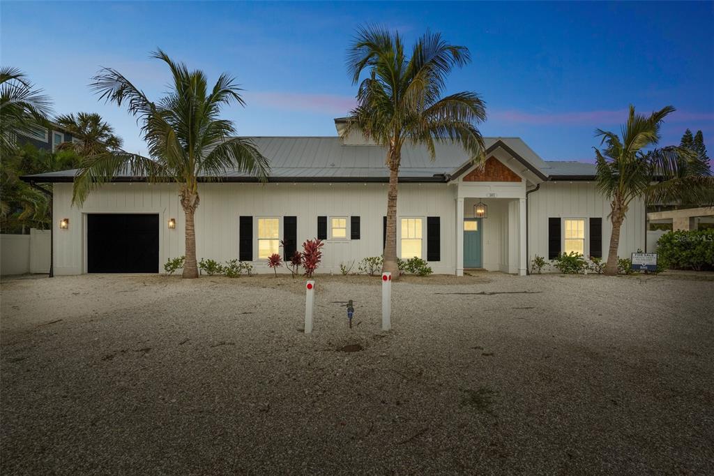 305 73rd Street Holmes Beach, FL 34217 - Photo 32 of 59 a view of a house with a yard and garage