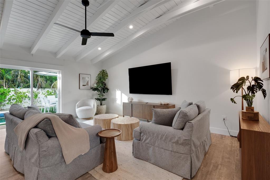 305 73rd Street Holmes Beach, FL 34217 - Photo 33 of 59 a living room with furniture and a flat screen tv
