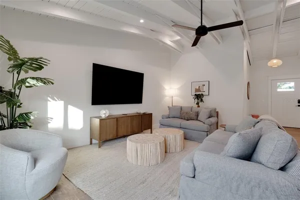 a kitchen with white cabinets and black appliances