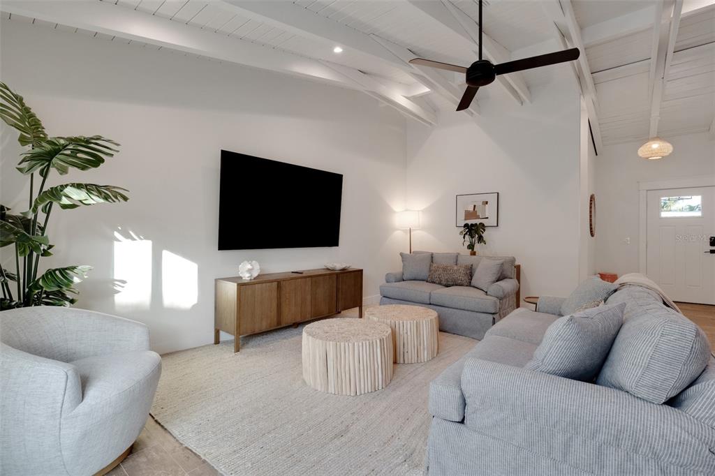 305 73rd Street Holmes Beach, FL 34217 - Photo 35 of 59 a living room with furniture and a flat screen tv