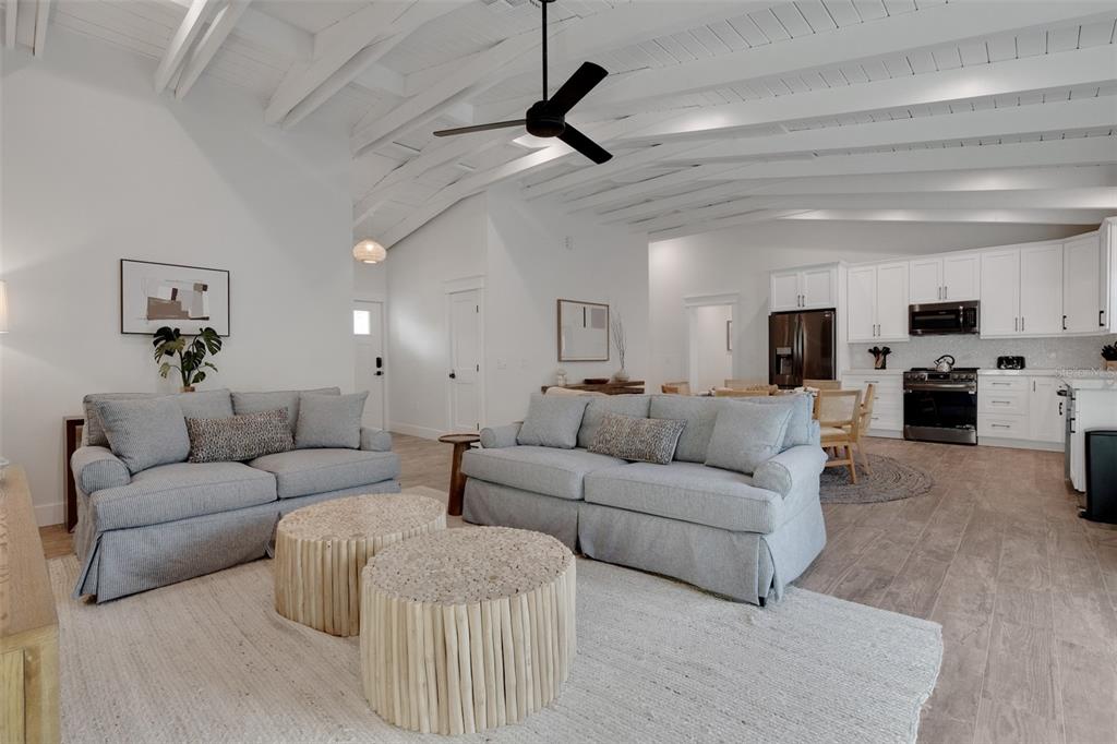 305 73rd Street Holmes Beach, FL 34217 - Photo 36 of 59 a living room with furniture white walls and kitchen view