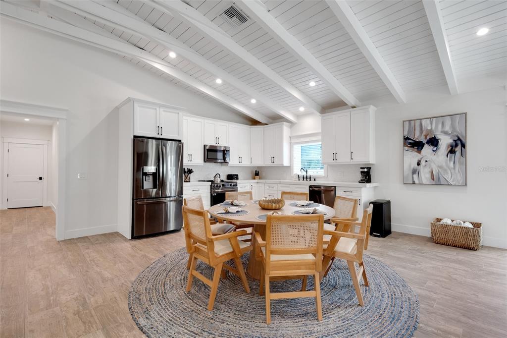 305 73rd Street Holmes Beach, FL 34217 - Photo 41 of 59 a view of a dining room with furniture and wooden floor