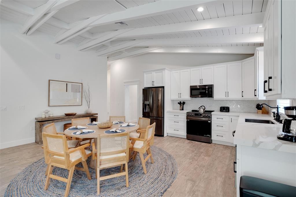 305 73rd Street Holmes Beach, FL 34217 - Photo 42 of 59 a view of a dining room with furniture and wooden floor