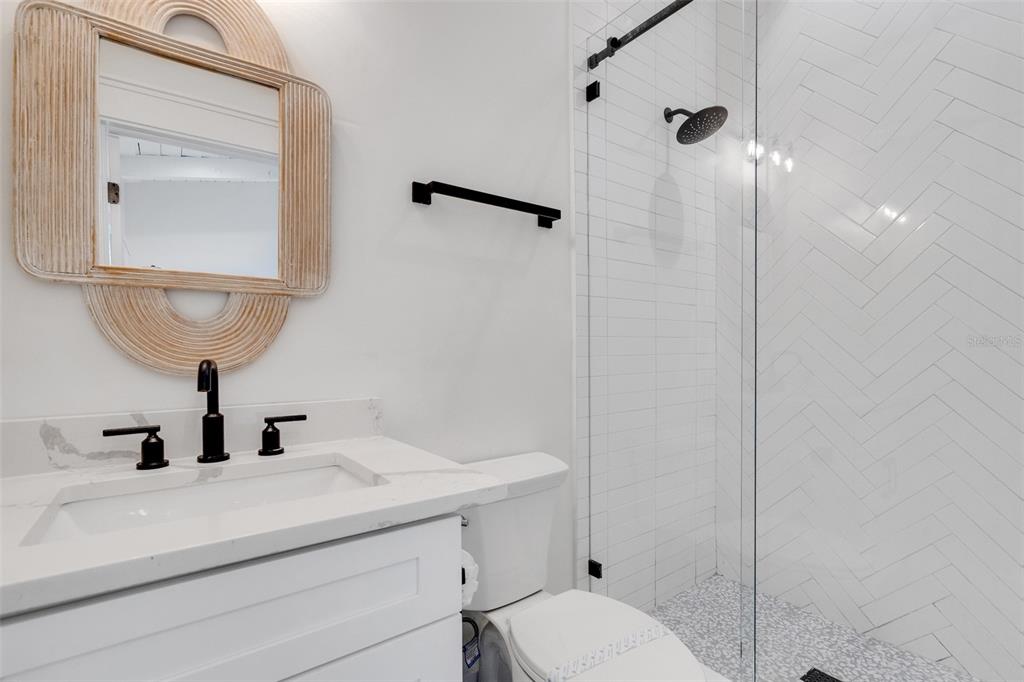 305 73rd Street Holmes Beach, FL 34217 - Photo 52 of 59 a bathroom with a sink a toilet and shower