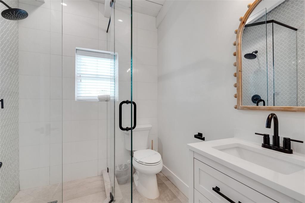 305 73rd Street Holmes Beach, FL 34217 - Photo 53 of 59 a bathroom with a toilet sink shower and mirror