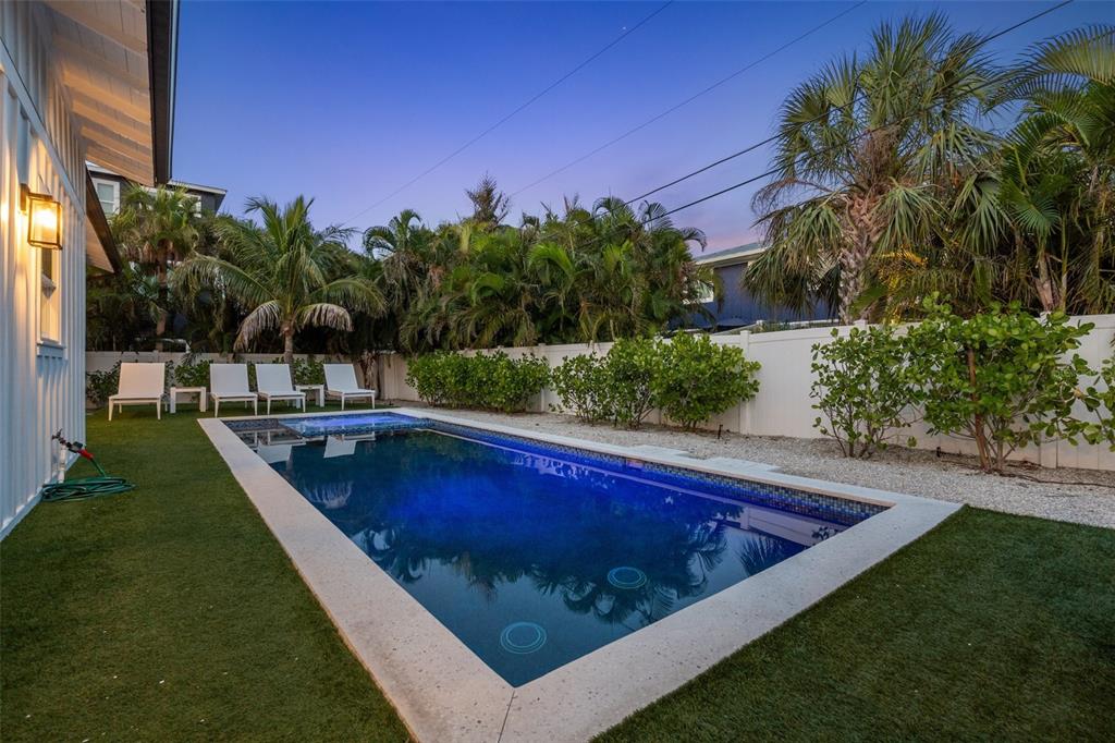 305 73rd Street Holmes Beach, FL 34217 - Photo 9 of 59 a view of a swimming pool with a yard