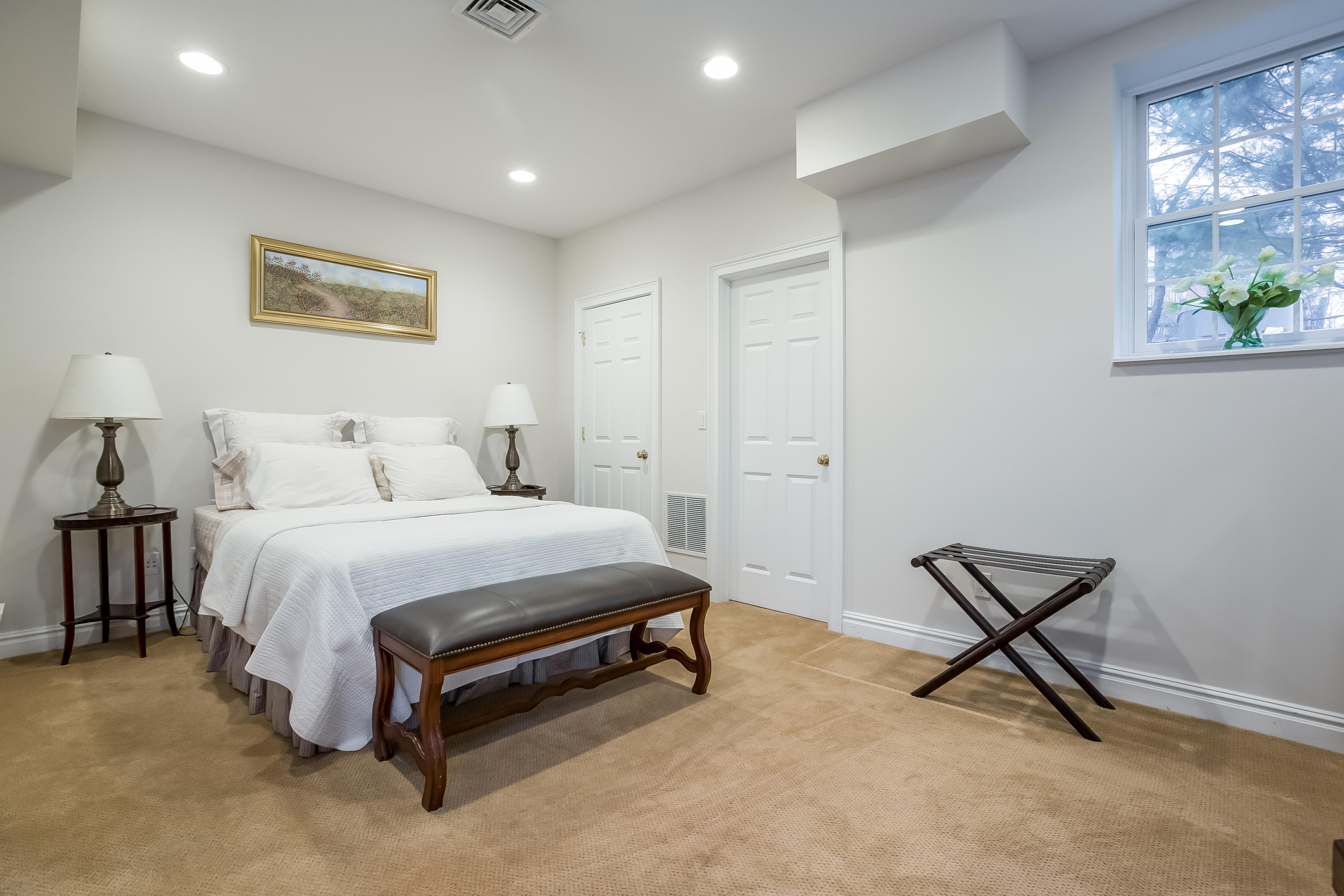 26 Indian Spring Road Rowayton, CT 06853 - Photo 24 of 33 a bedroom with a bed and a painting on the wall