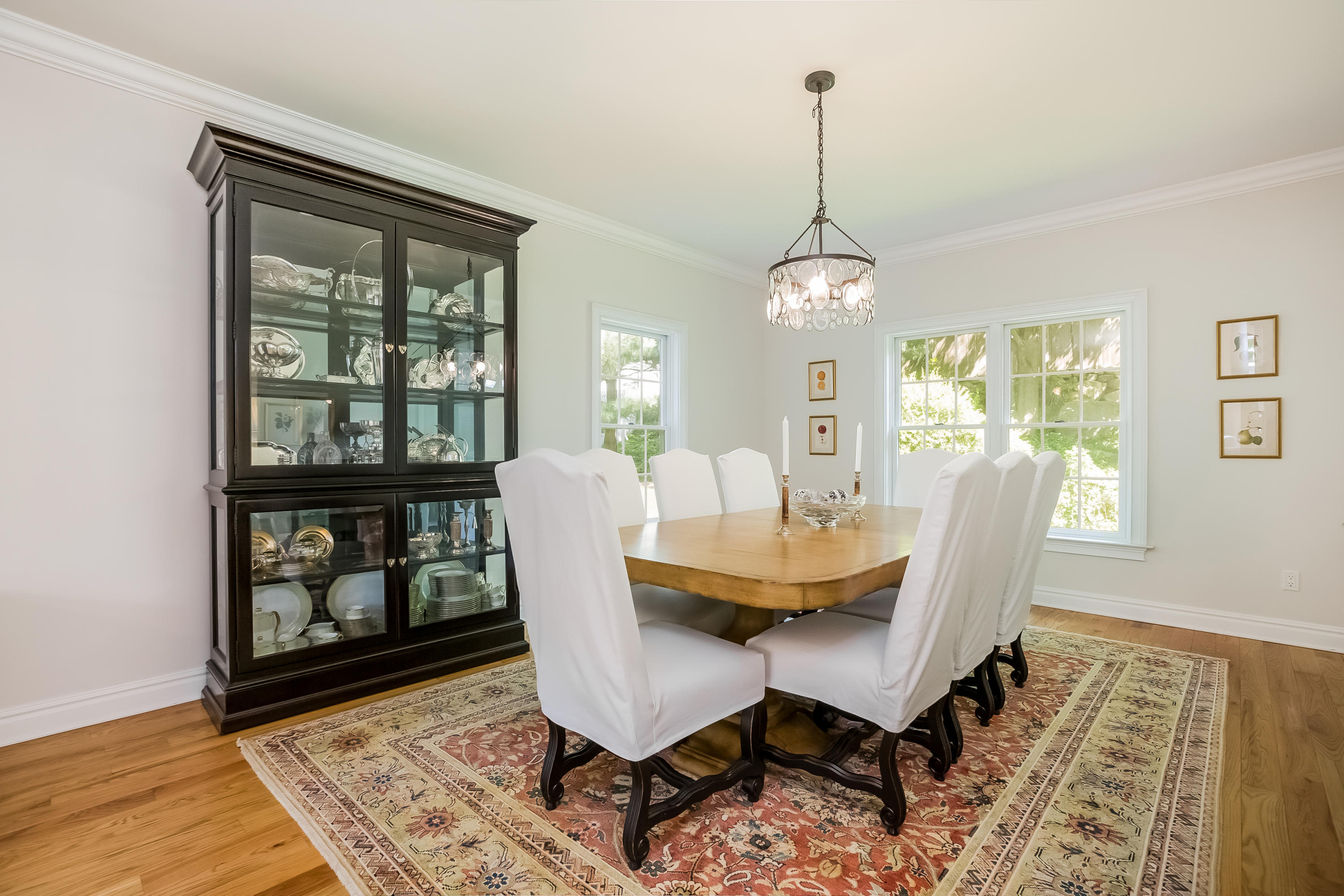 26 Indian Spring Road Rowayton, CT 06853 - Photo 7 of 33 a dining room with furniture a chandelier and wooden floor