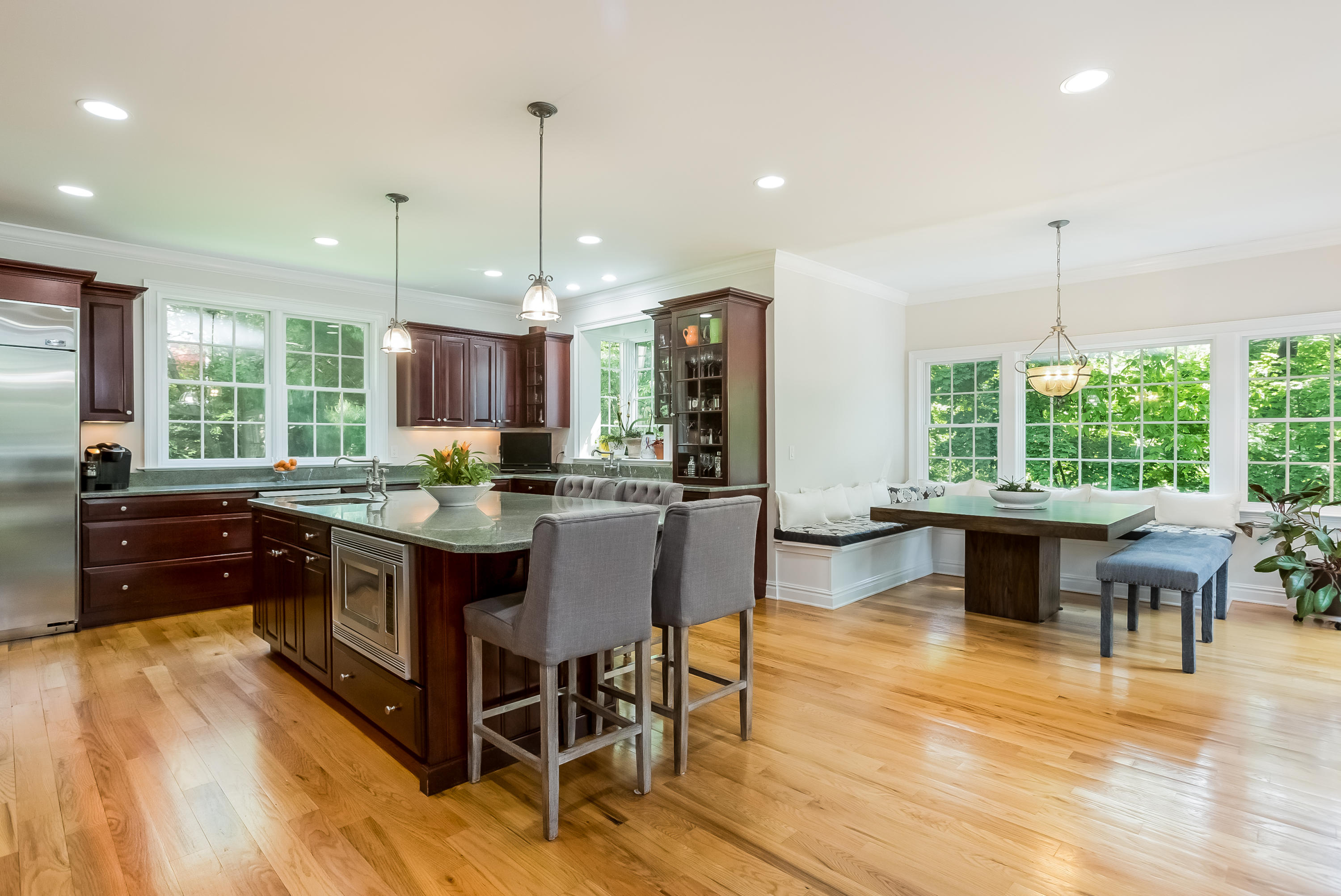 26 Indian Spring Road Rowayton, CT 06853 - Photo 9 of 33 a kitchen with stainless steel appliances granite countertop a stove a refrigerator a kitchen island a couches and chairs with wooden floor