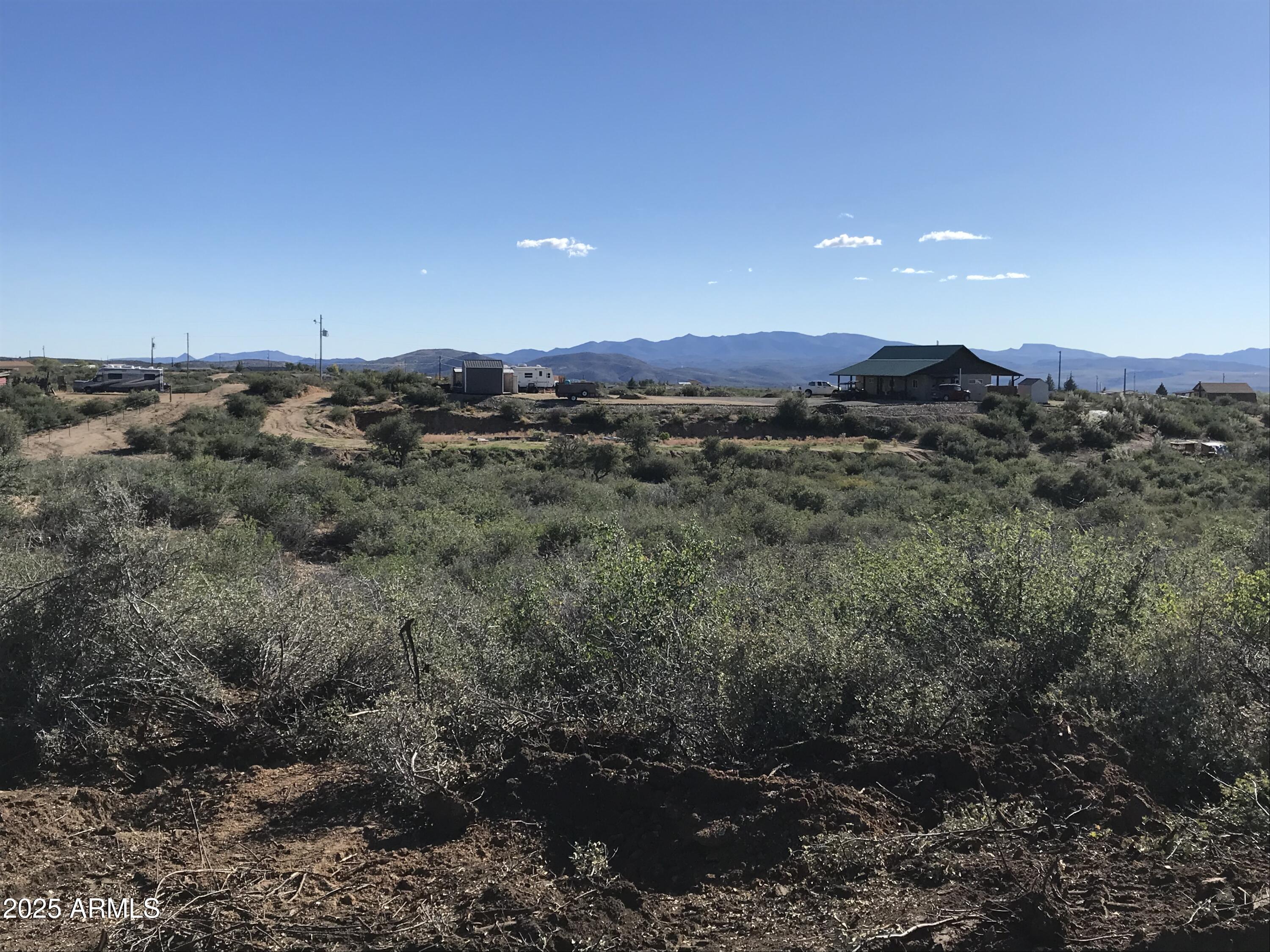 8335 West Barrington Road, Unit 107 Wilhoit, AZ 86332 - Photo 8 of 13 a view of a dry yard with wooden floor and a mountain view