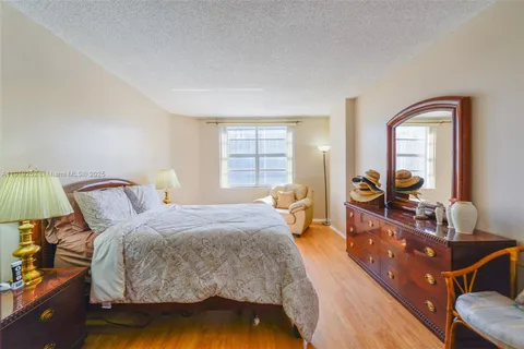 a bed room with a bed and a television