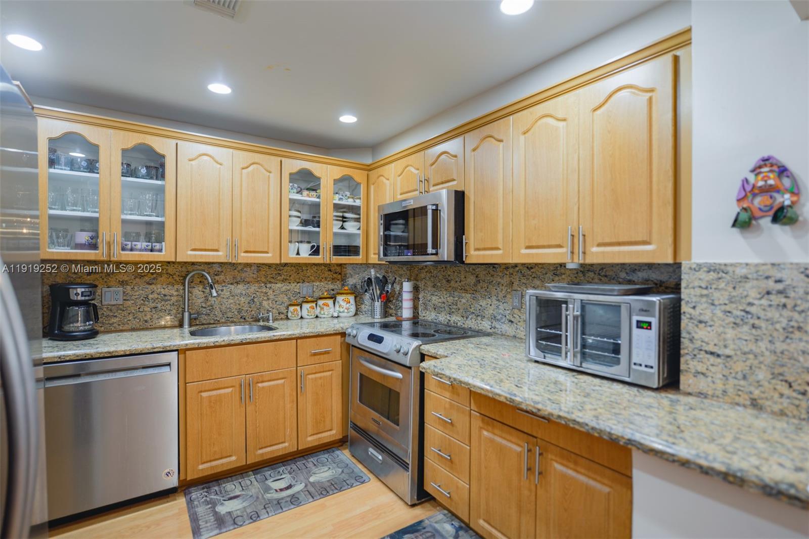 1985 South Ocean Drive, Unit 6J Hallandale Beach, FL 33009 - Photo 10 of 38 a kitchen with stainless steel appliances granite countertop a sink stove and cabinets