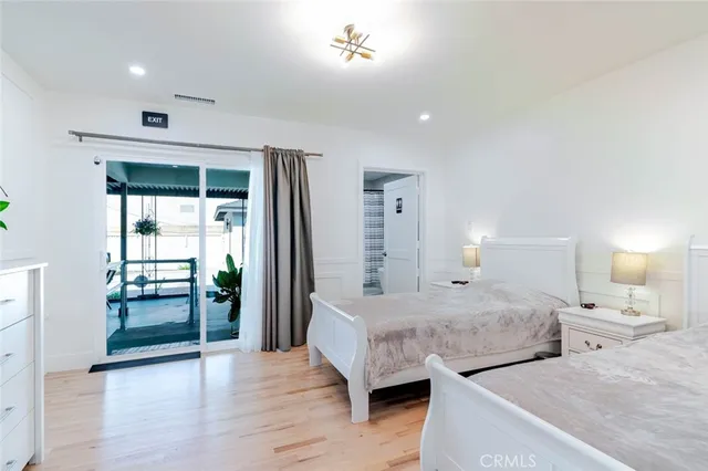 a bedroom with bed and a large window