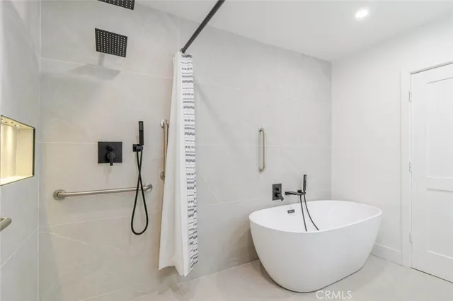 a bathroom with a bathtub and shower