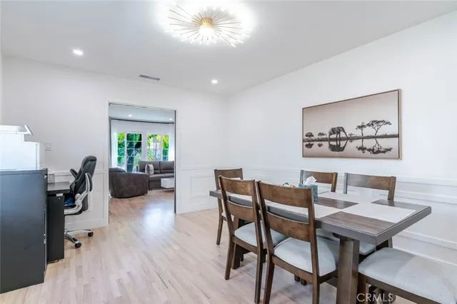 a view of a dining room with furniture and a wooden floor