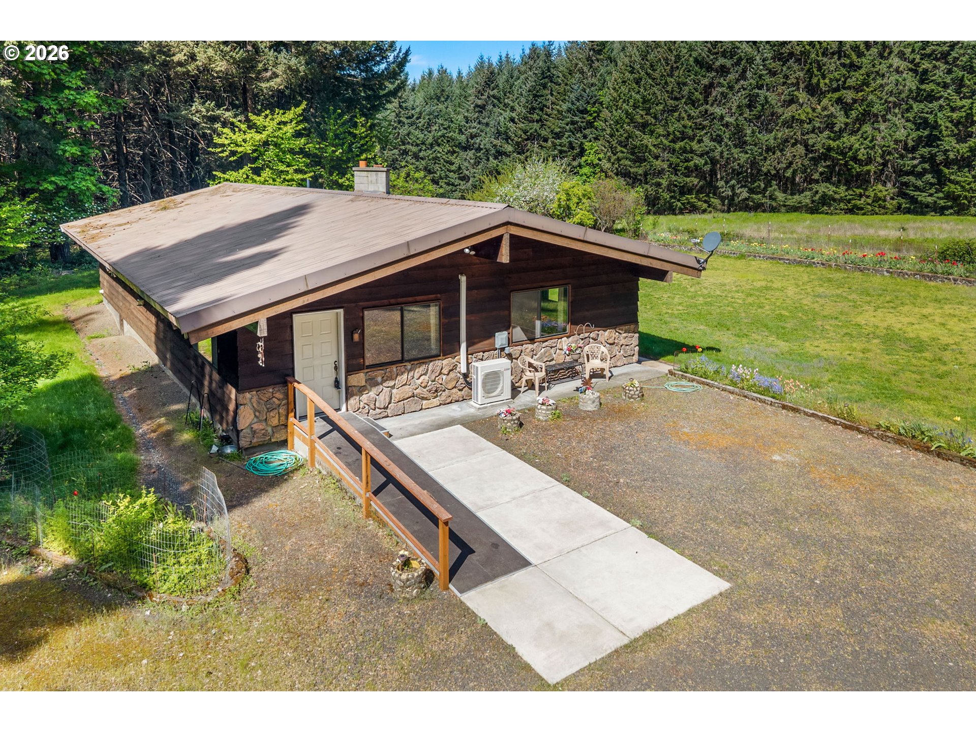 586 Northwest Loop Road White Salmon, WA 98672 - Photo 14 of 48 a backyard of a house with table and chairs