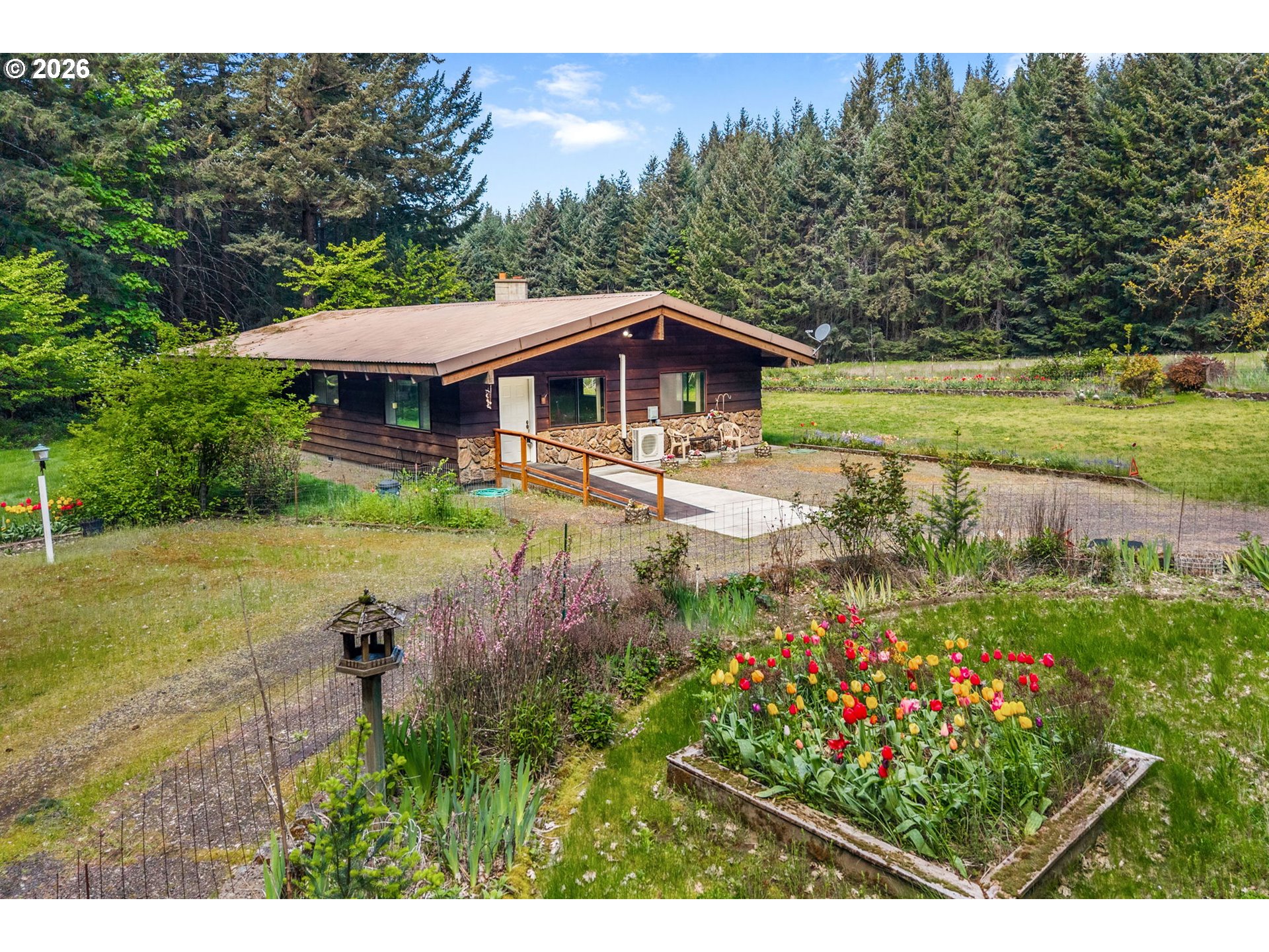 586 Northwest Loop Road White Salmon, WA 98672 - Photo 3 of 48 a view of a garden with an outdoor seating