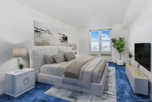 a spacious bedroom with a bed and a flat screen television