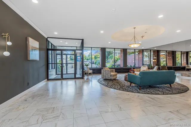 a living room with furniture and large windows