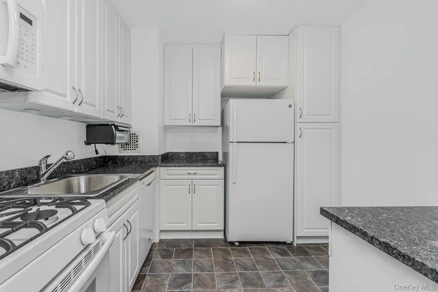 a kitchen with a sink a stove and refrigerator