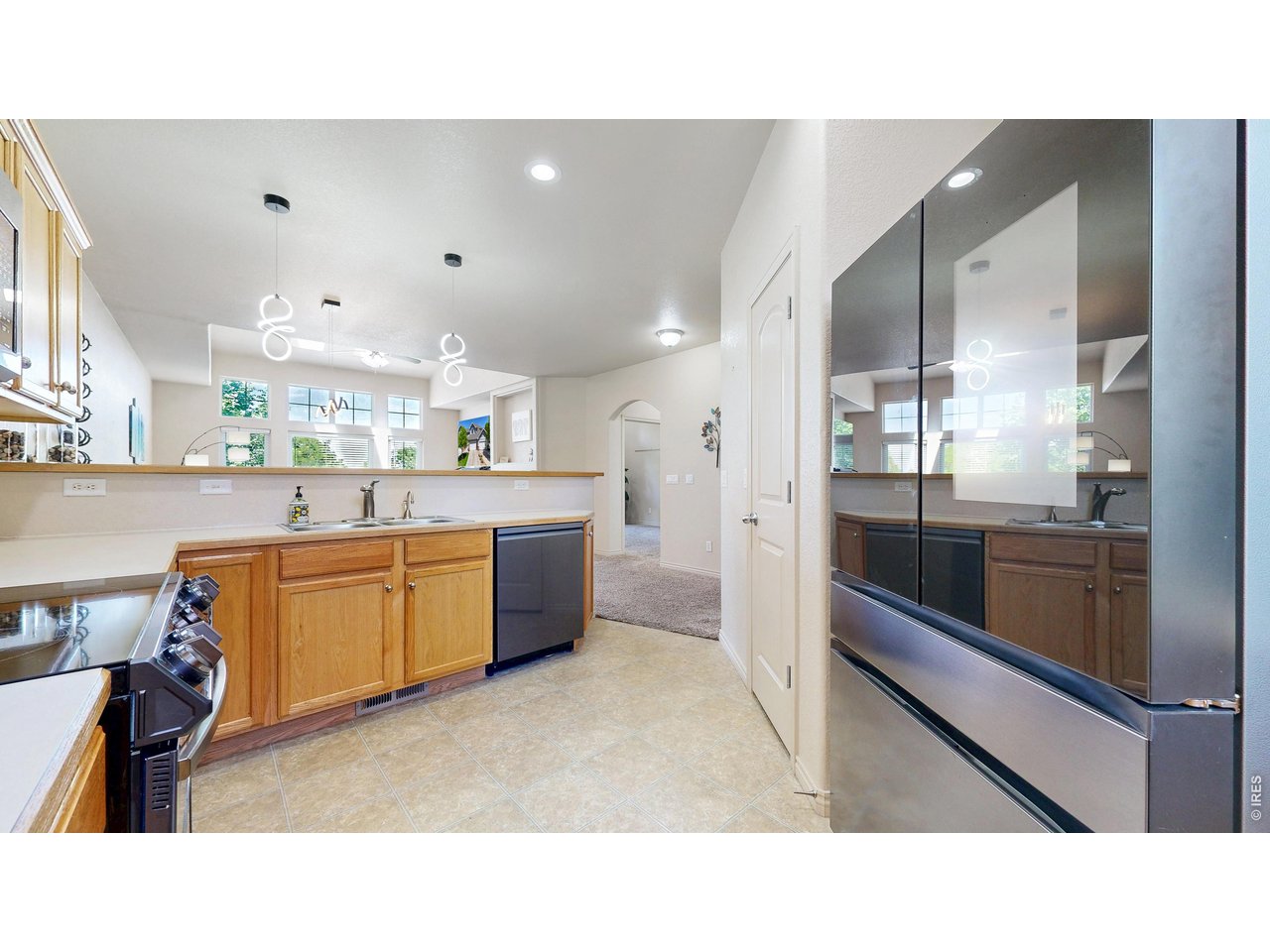 4672 West 20th Road, Unit 413 Greeley, CO 80634 - Photo 12 of 37 a open kitchen with stainless steel appliances kitchen island granite countertop a large counter top and stainless steel appliances