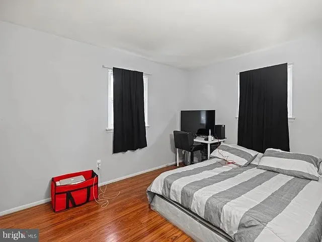 a bedroom with a bed and a television