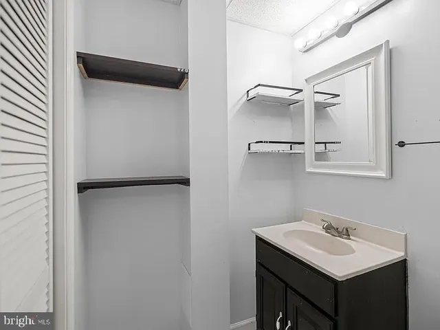 a bathroom with a sink and mirror
