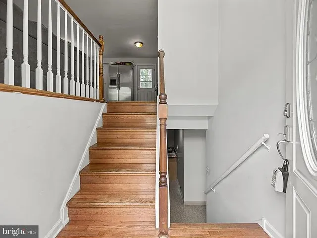 a view of entryway and hall with wooden floor