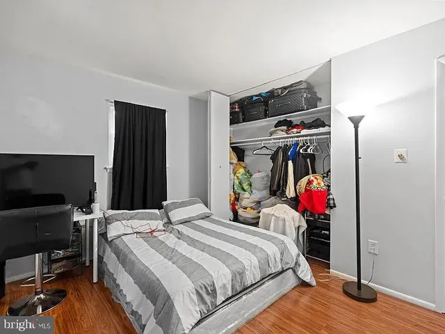 a bed room with a bed and a flat screen tv