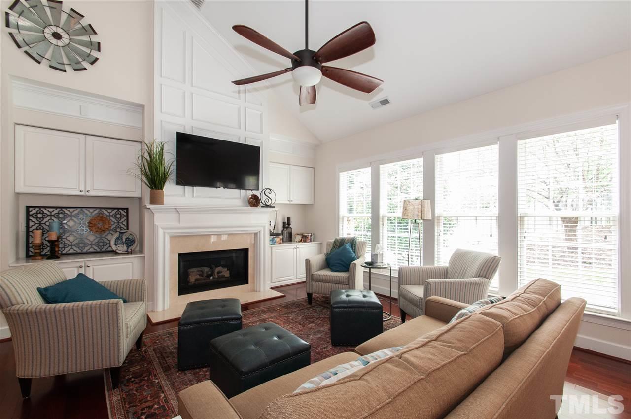 3615 Lion Ridge Court Raleigh, NC 27612 - Photo 2 of 30 a living room with furniture a fireplace and a flat screen tv