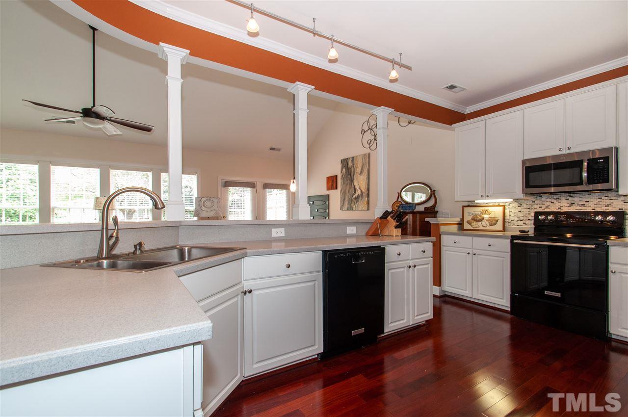 3615 Lion Ridge Court Raleigh, NC 27612 - Photo 11 of 30 a kitchen with sink a microwave and cabinets
