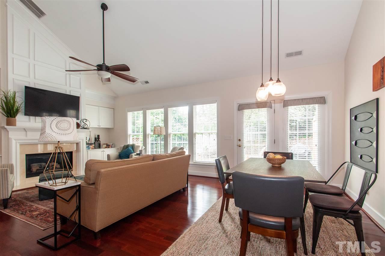 3615 Lion Ridge Court Raleigh, NC 27612 - Photo 13 of 30 a living room with furniture a fireplace and a flat screen tv