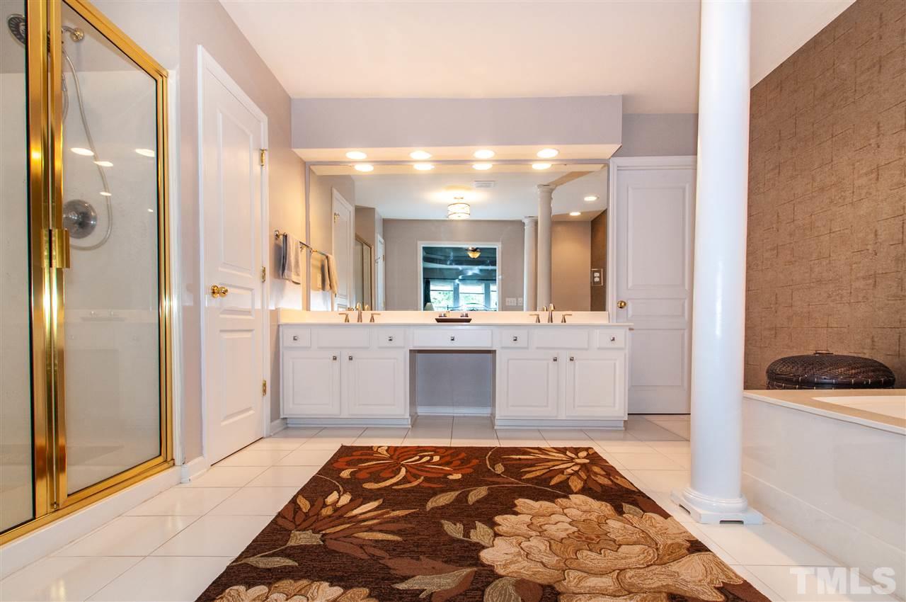 3615 Lion Ridge Court Raleigh, NC 27612 - Photo 21 of 30 a bathroom with a sink a toilet a mirror and shower