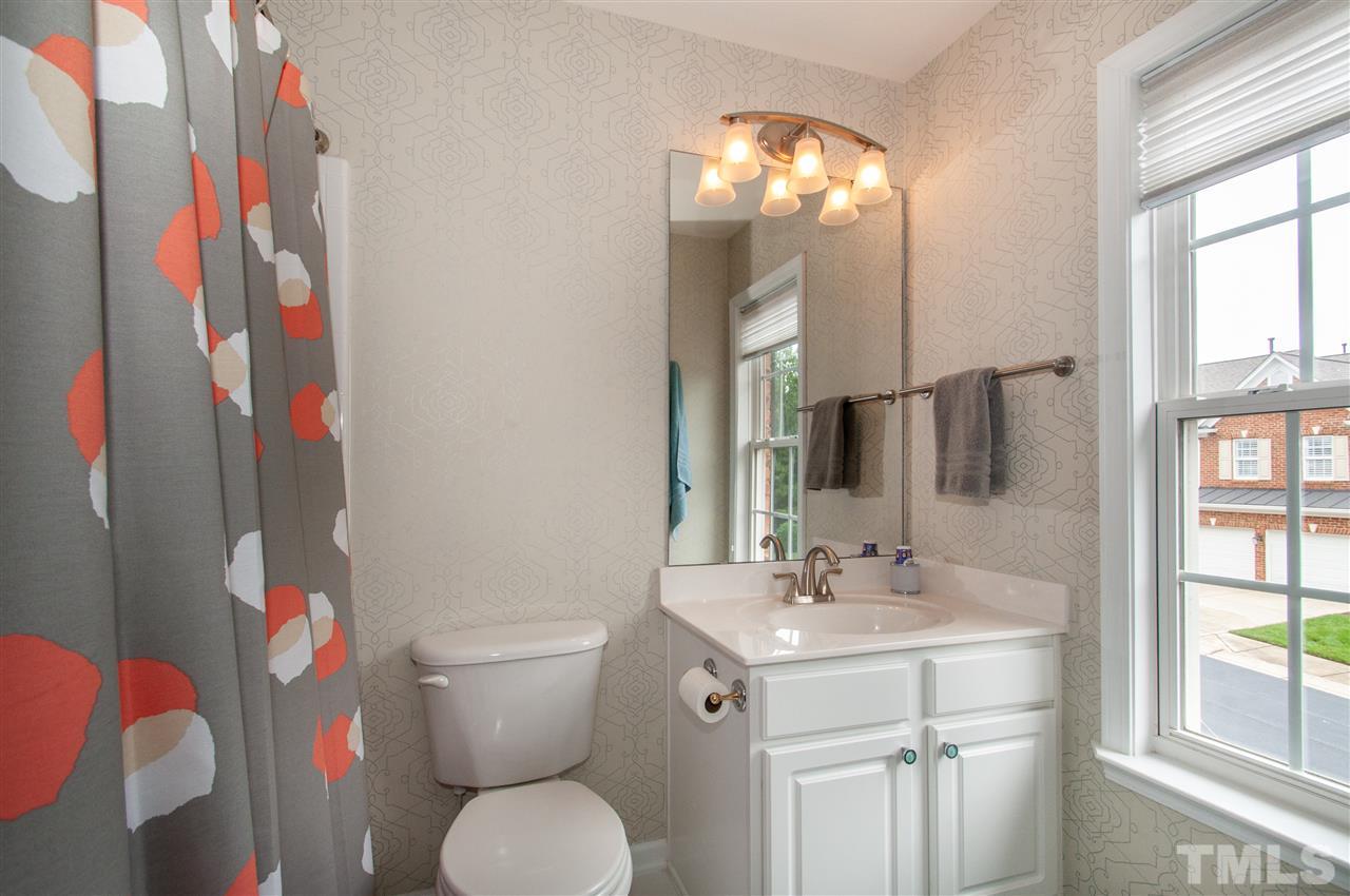 3615 Lion Ridge Court Raleigh, NC 27612 - Photo 24 of 30 a bathroom with a sink toilet and window