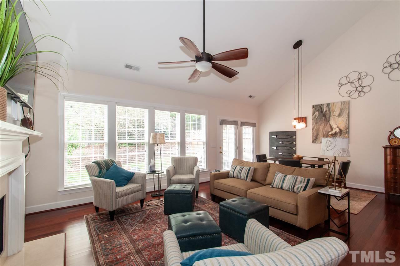 3615 Lion Ridge Court Raleigh, NC 27612 - Photo 4 of 30 a living room with furniture large window and a fireplace