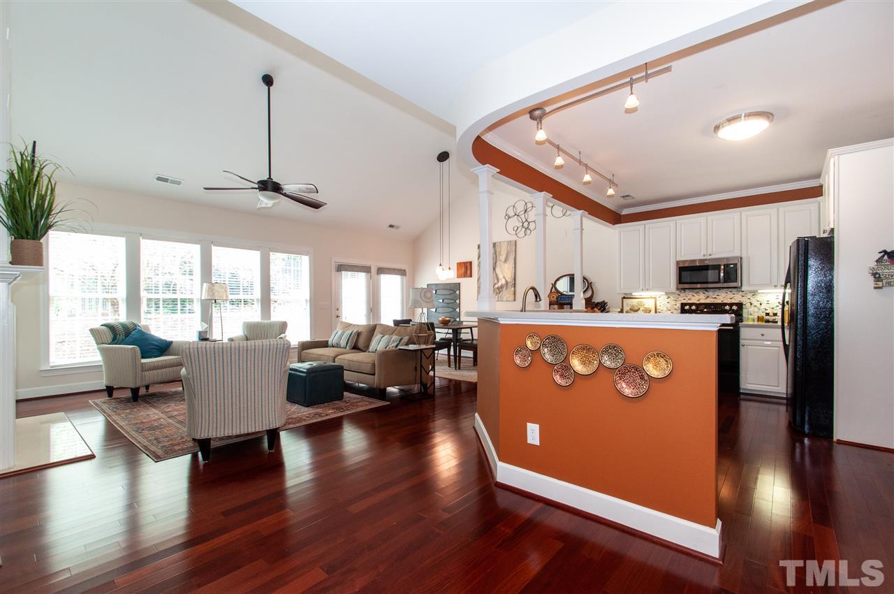 3615 Lion Ridge Court Raleigh, NC 27612 - Photo 10 of 30 a living room with stainless steel appliances granite countertop a refrigerator a sink dishwasher a dining table and chairs with wooden floor