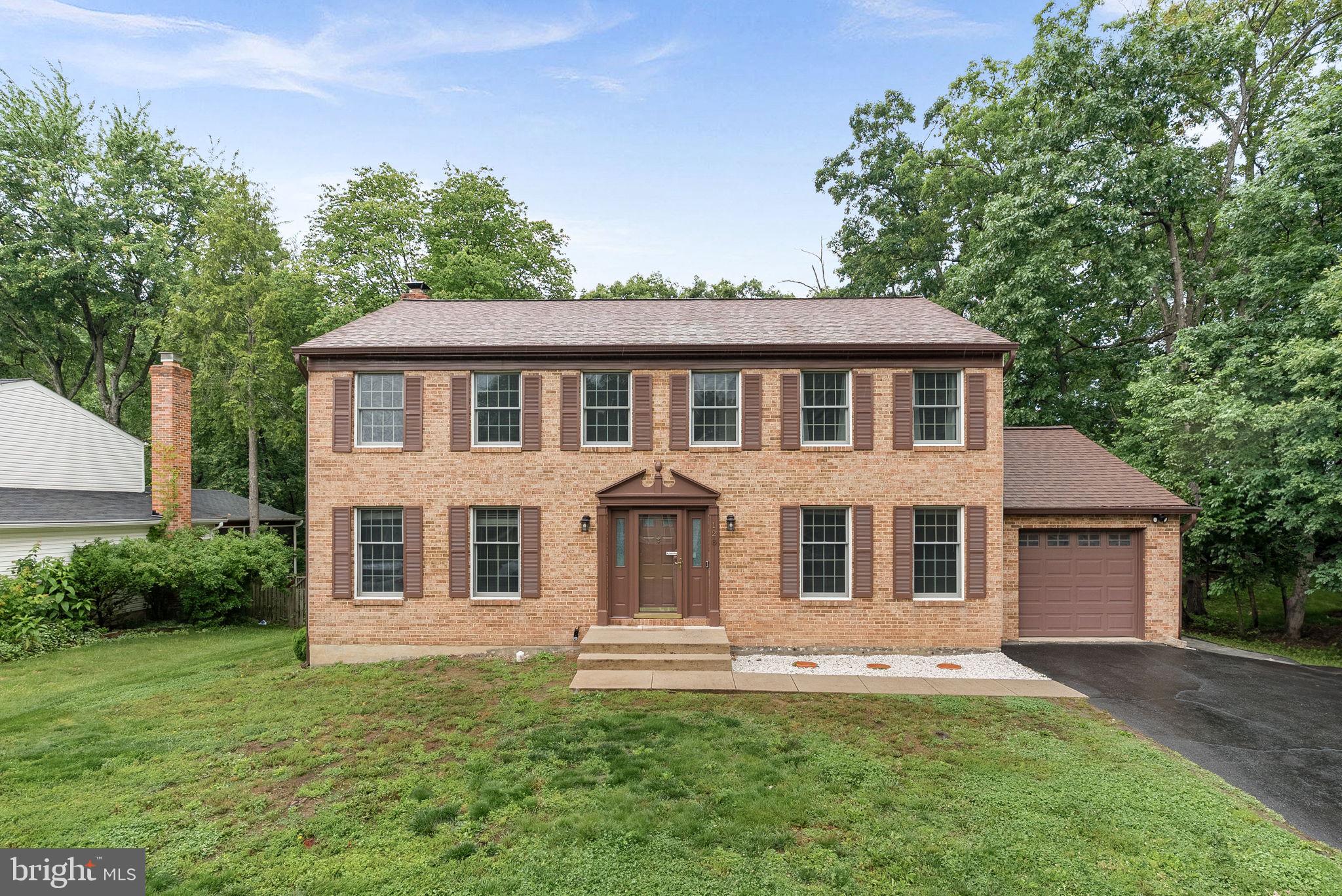 128 Applegate Drive Sterling, VA 20164 - Photo 1 of 58 a front view of a house with a garden
