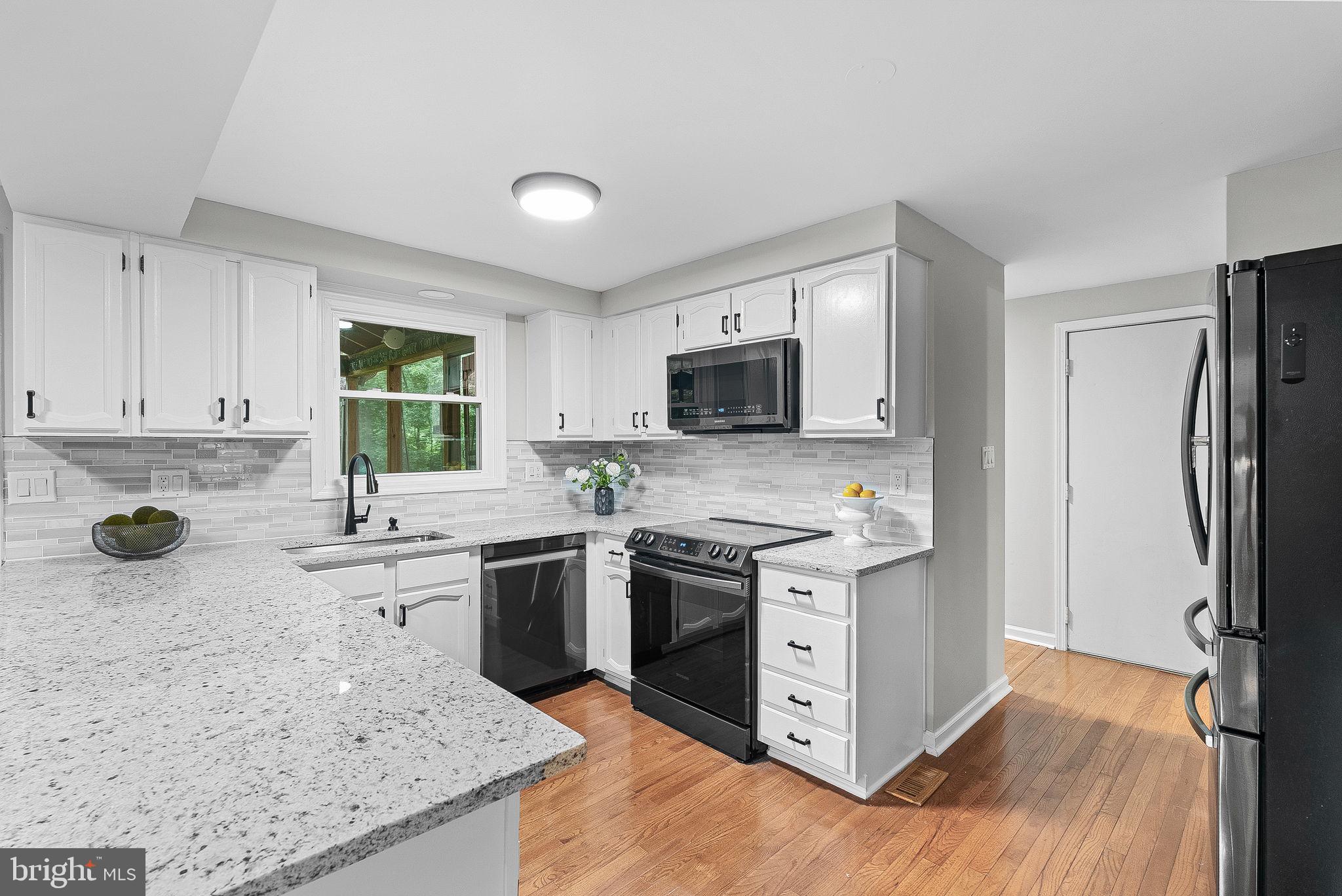 128 Applegate Drive Sterling, VA 20164 - Photo 24 of 58 a kitchen with stainless steel appliances granite countertop a stove top oven a sink dishwasher a refrigerator and a oven with wooden floor