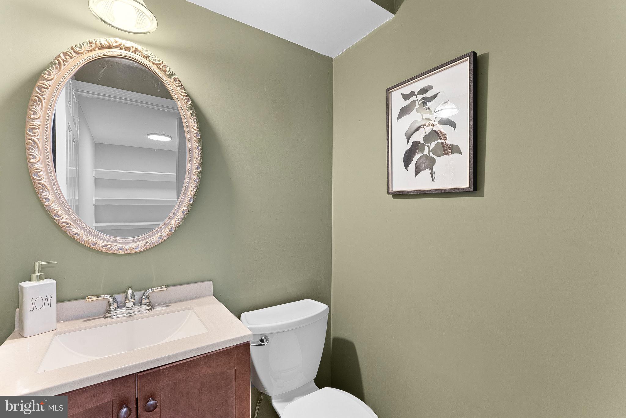 128 Applegate Drive Sterling, VA 20164 - Photo 26 of 58 a bathroom with a toilet sink vanity and mirror