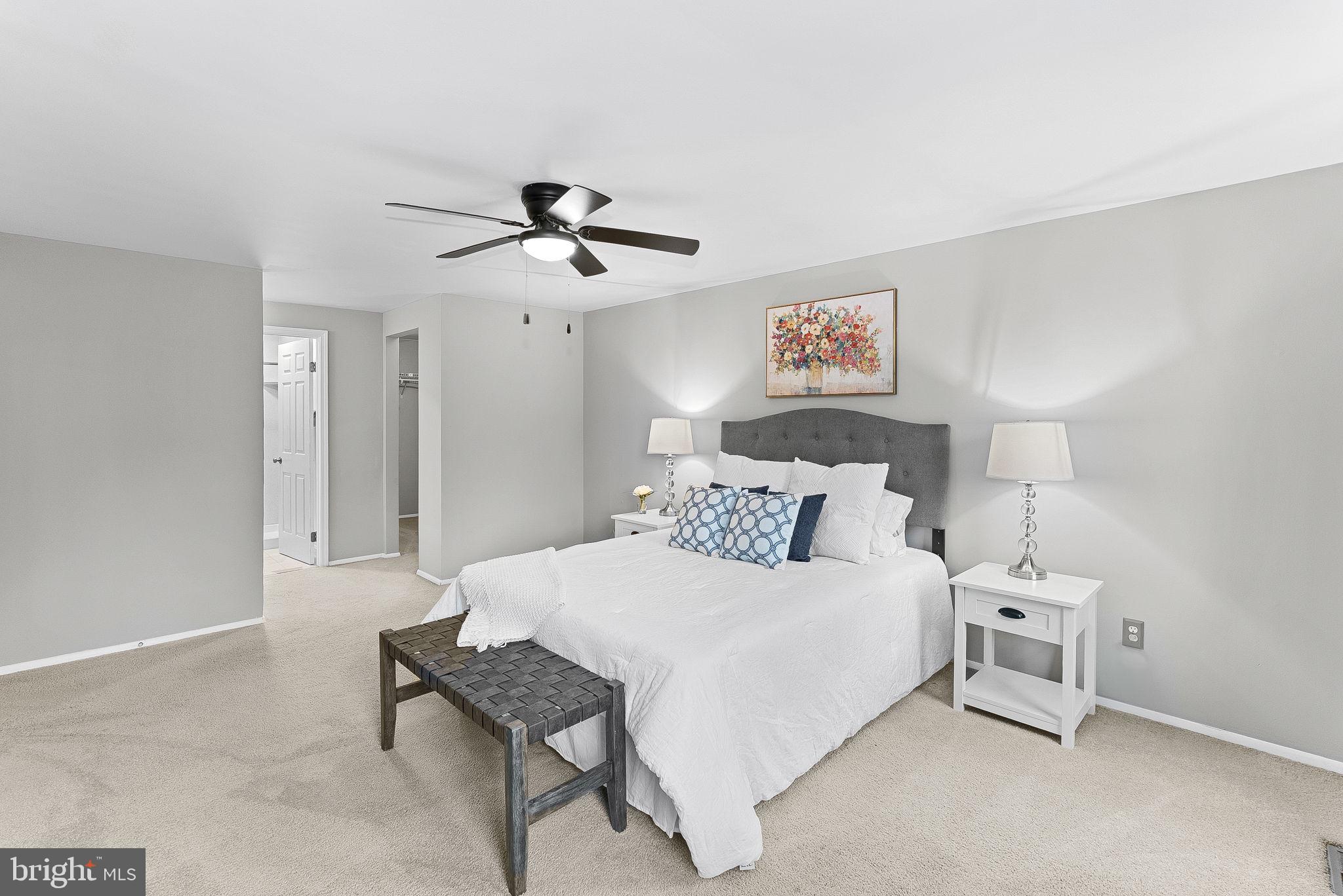 128 Applegate Drive Sterling, VA 20164 - Photo 28 of 58 a bedroom with a bed and a chandelier