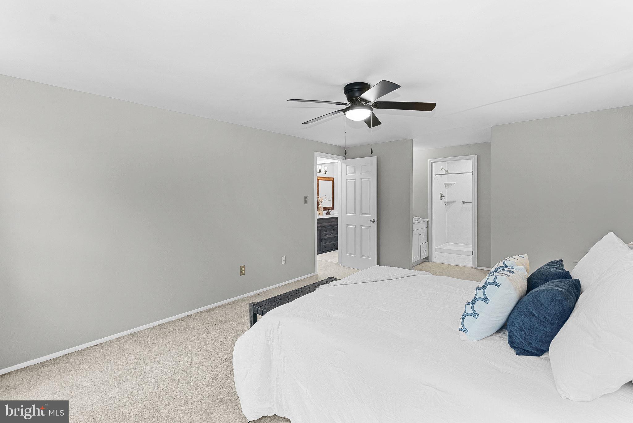 128 Applegate Drive Sterling, VA 20164 - Photo 29 of 58 a spacious bedroom with a bed and a ceiling fan