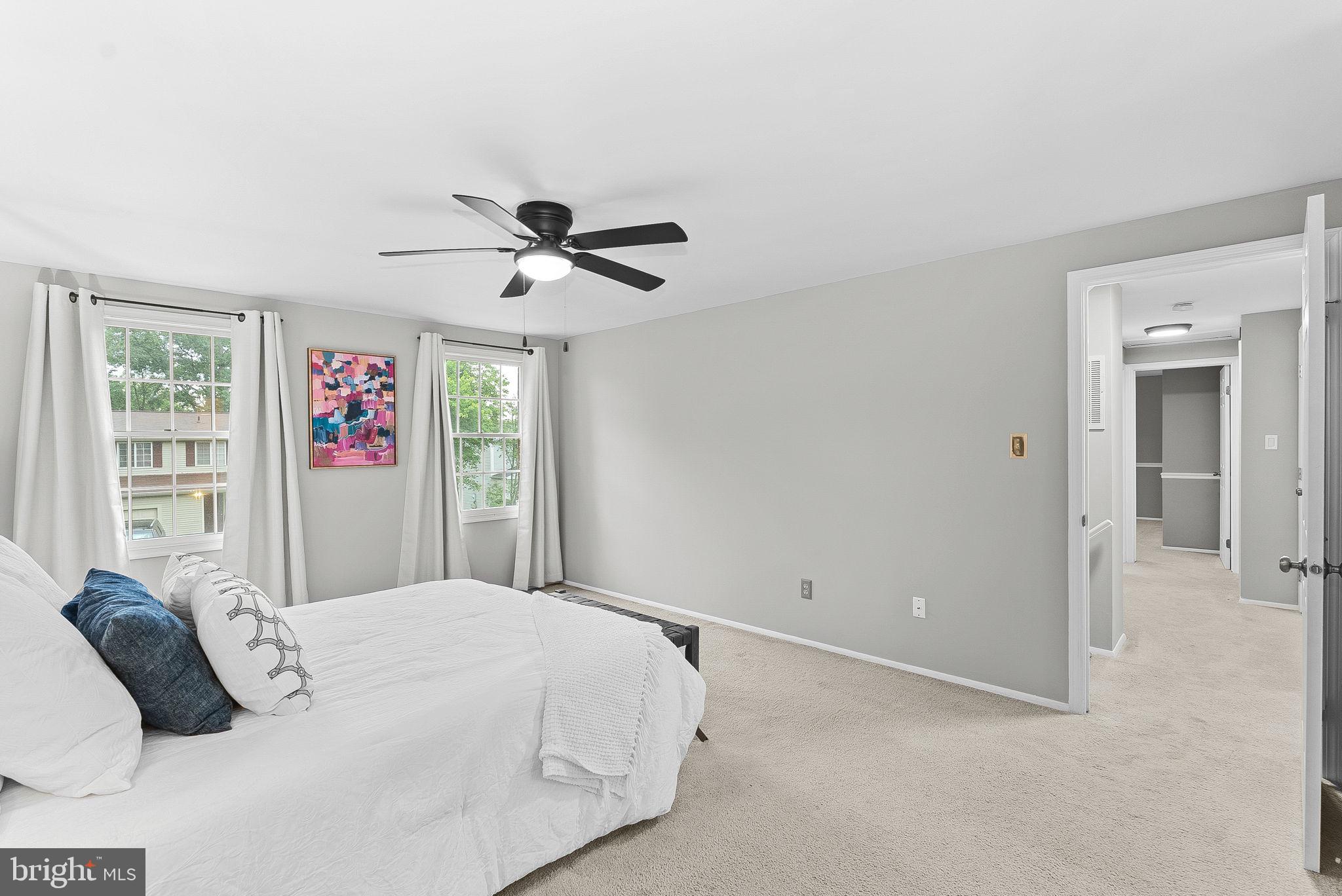 128 Applegate Drive Sterling, VA 20164 - Photo 30 of 58 a bedroom with a large bed and a chandelier