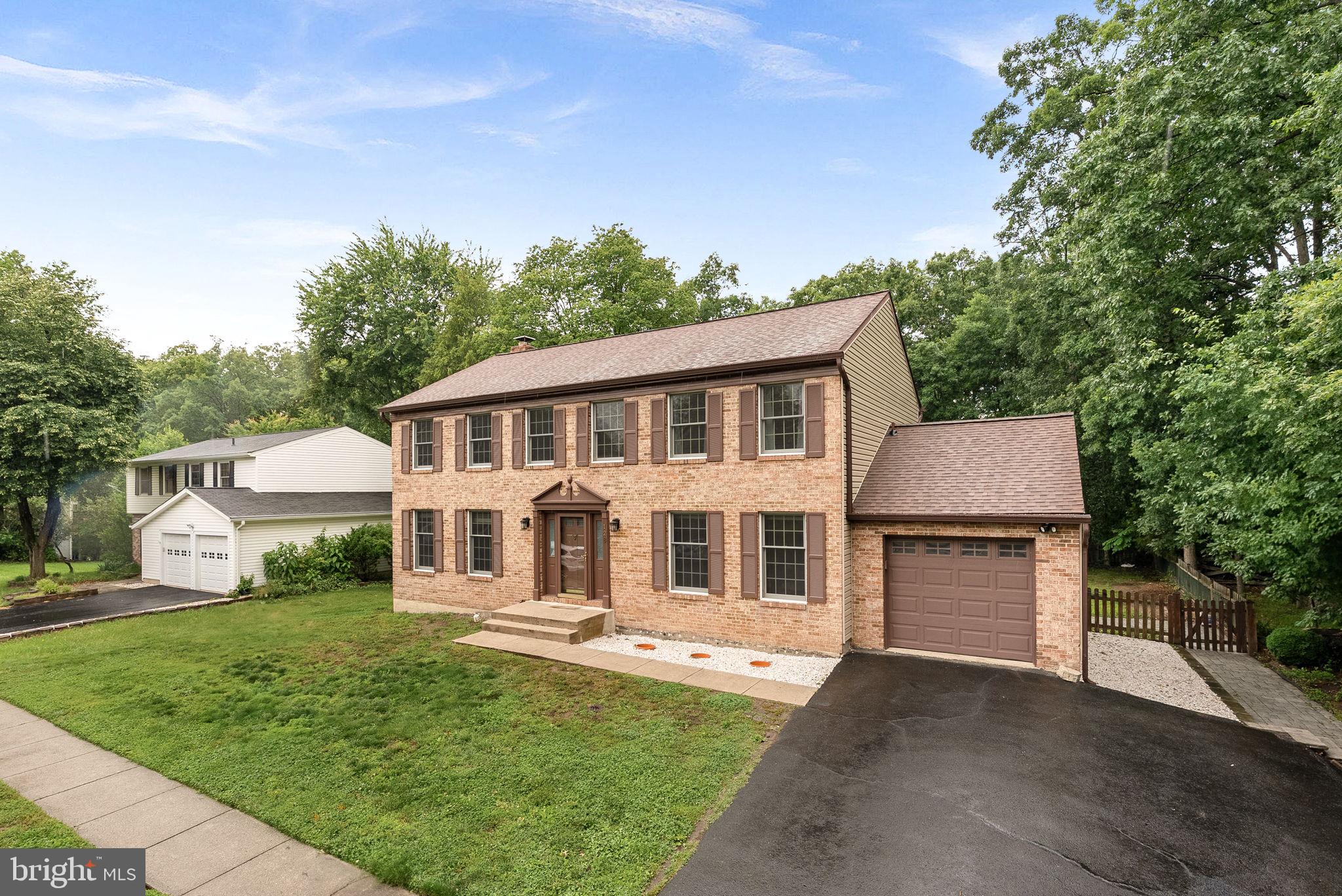 128 Applegate Drive Sterling, VA 20164 - Photo 3 of 58 a front view of a house with a yard and garage