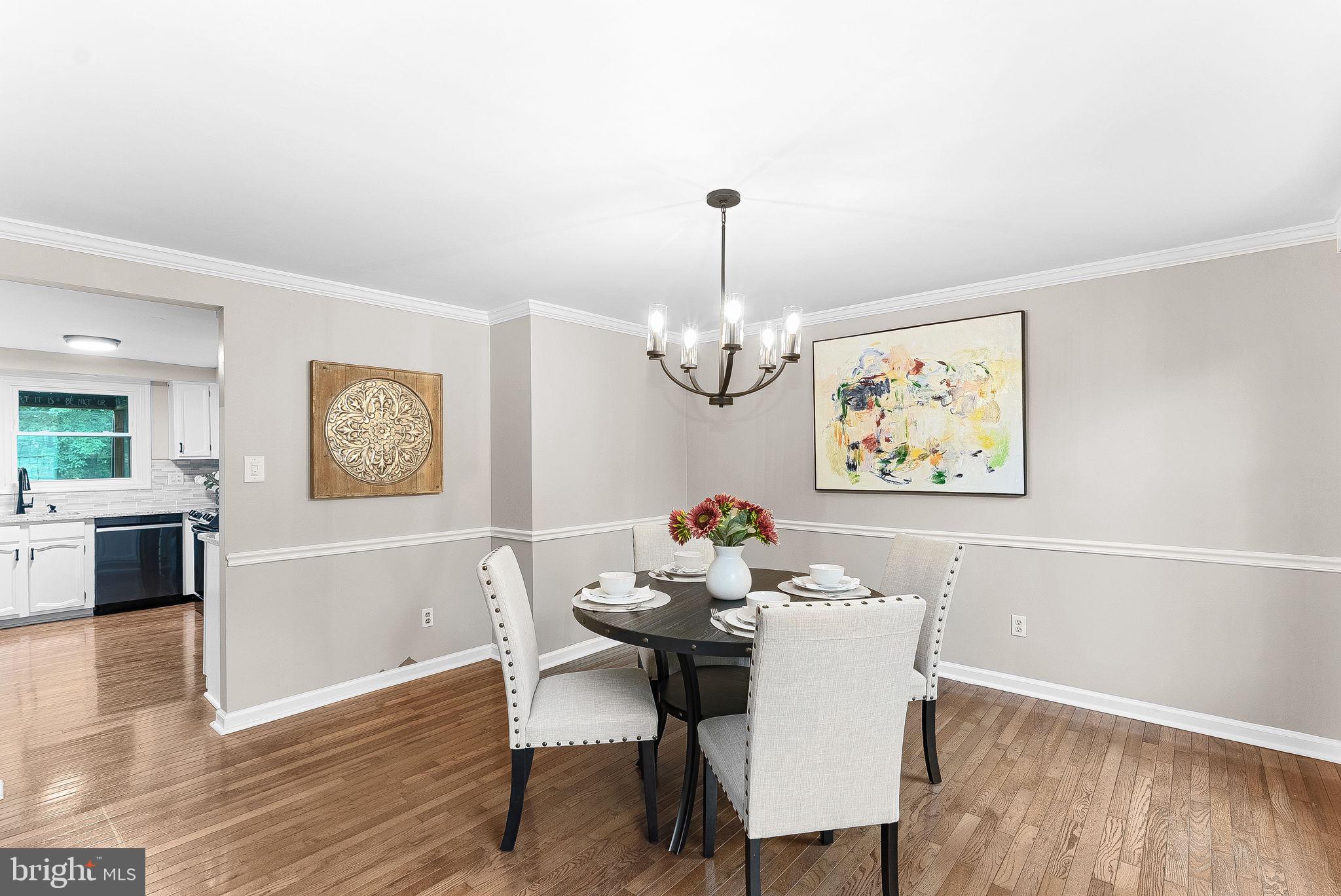 128 Applegate Drive Sterling, VA 20164 - Photo 8 of 58 a view of a dining room with furniture wooden floor and a chandelier