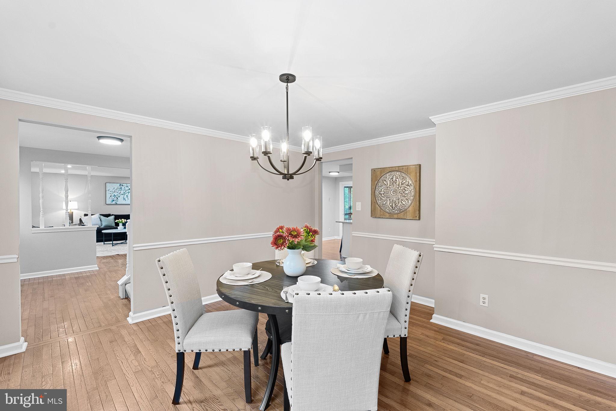 128 Applegate Drive Sterling, VA 20164 - Photo 9 of 58 a view of a dining room with furniture a chandelier and wooden floor