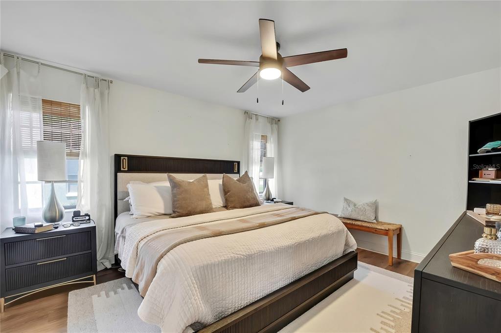 14154 Trollman Street Spring Hill, FL 34609 - Photo 11 of 25 a bedroom with a bed and a chandelier