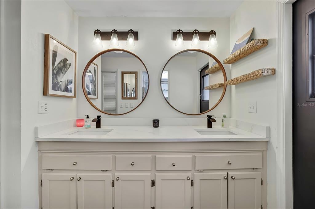 14154 Trollman Street Spring Hill, FL 34609 - Photo 12 of 25 a bathroom with a sink and a mirror